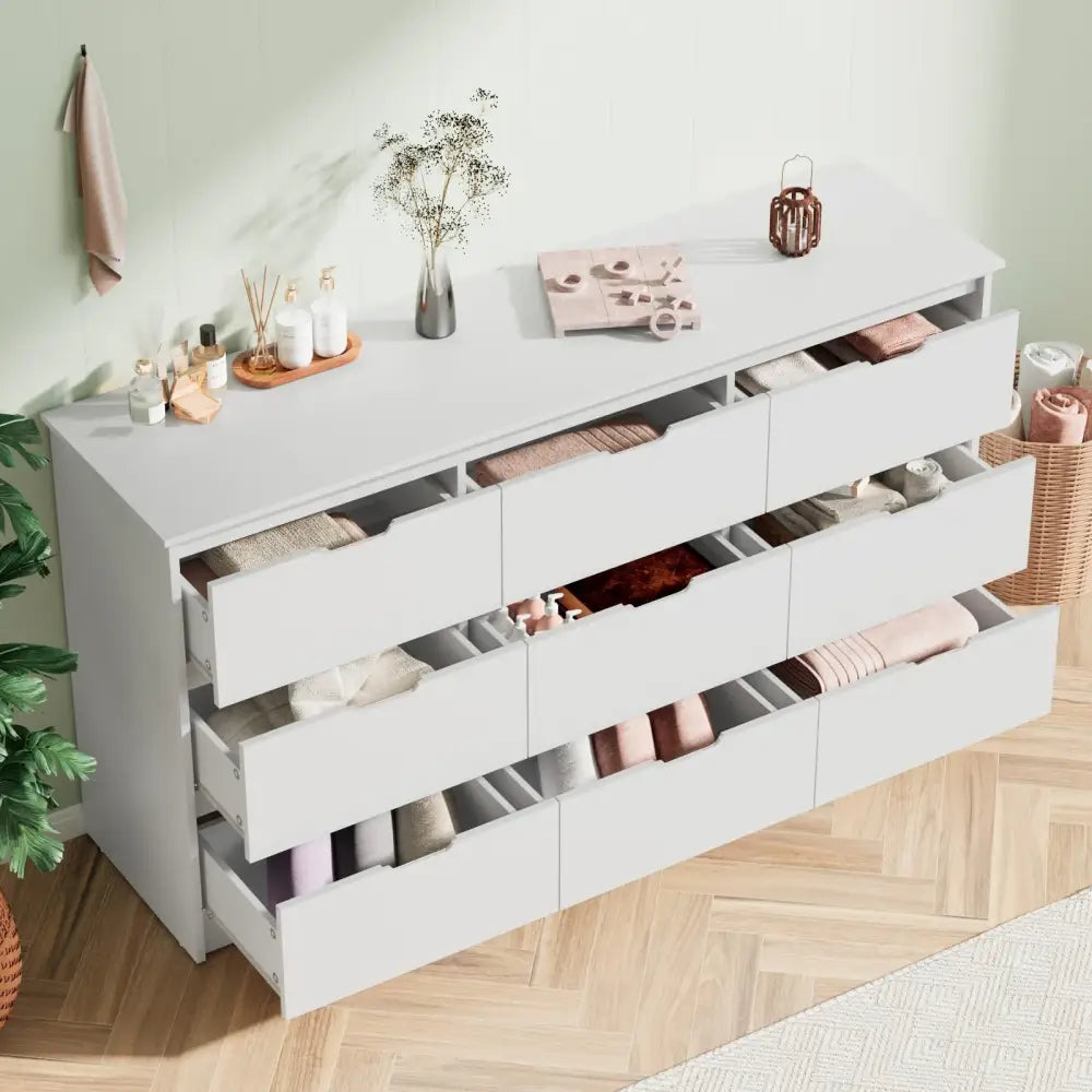 White bedroom dresser with wide top, open drawers, and anti-toppling device protection