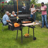Black charcoal grill with food, featuring durable painted stainless steel construction