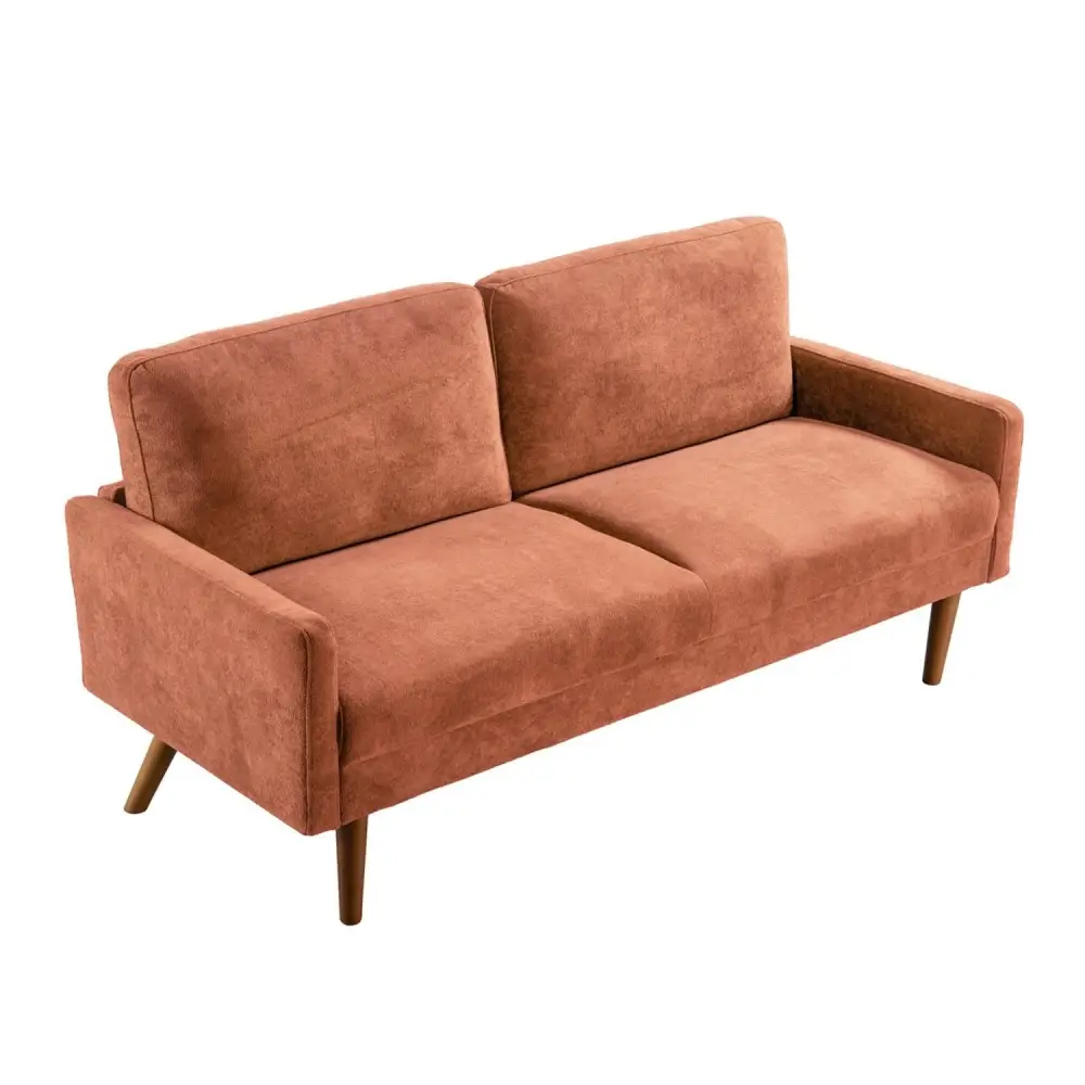 Rust-colored velvet couch with wooden legs for a chic living room setting
