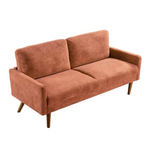 Rust-colored velvet couch with wooden legs for a chic living room setting