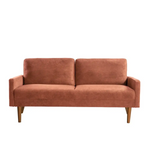 Two-cushion copper-colored velvet couch in chic living room setting