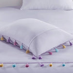 White pillow with colorful tassels from Lavender Tassel Comforter with Heart Shaped Throw Pillow Set