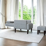 Gray upholstered sofa and ottoman in a modern living room setup with single chair