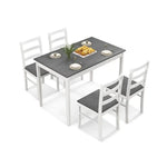 Rectangular dining table with wood veneer and supporting wood legs with four chairs