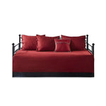 Red plaid reversible daybed cover set with decorative pillows on a stylish daybed