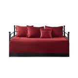Red plaid reversible daybed cover set with decorative pillows on a stylish daybed