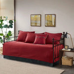 Red plaid reversible daybed cover set with decorative pillows on a stylish daybed