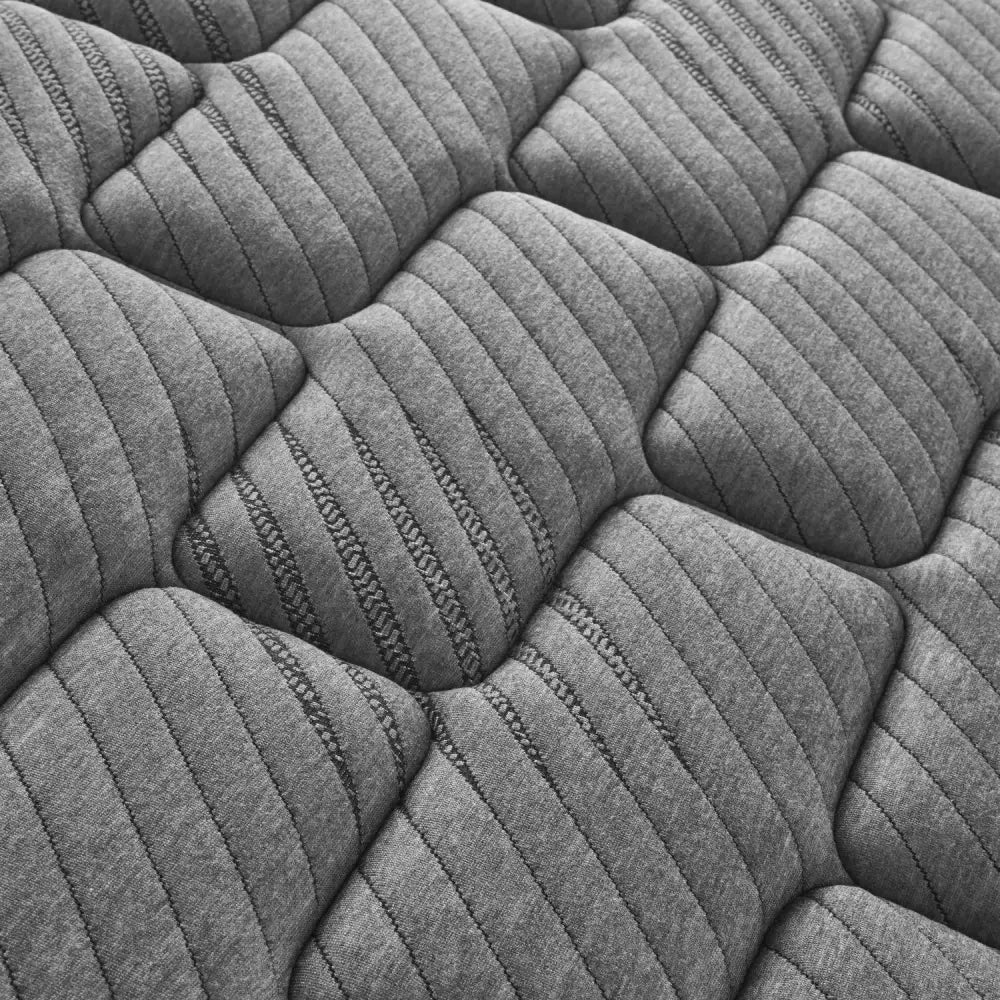 Gray quilted mattress surface of Twin XL Firm Quilted Hybrid Mattress for comfortable sleep