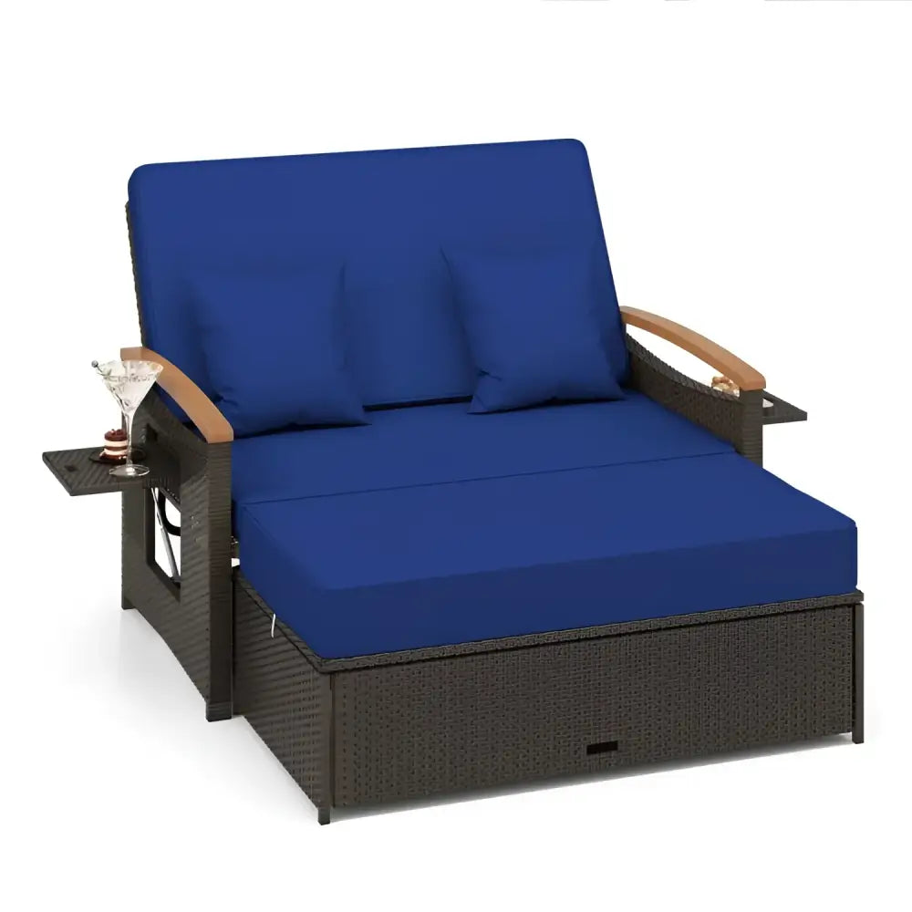 Blue cushioned wicker outdoor daybed with ottoman cushion in conversation set for comfort